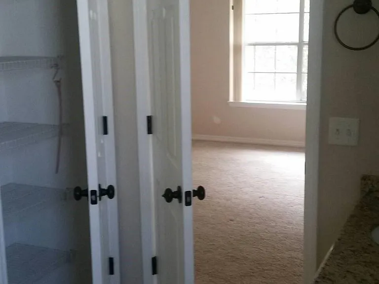 view into master bedroom from bathroom
