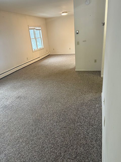 Enter into the large living room space that opens into a dining room.