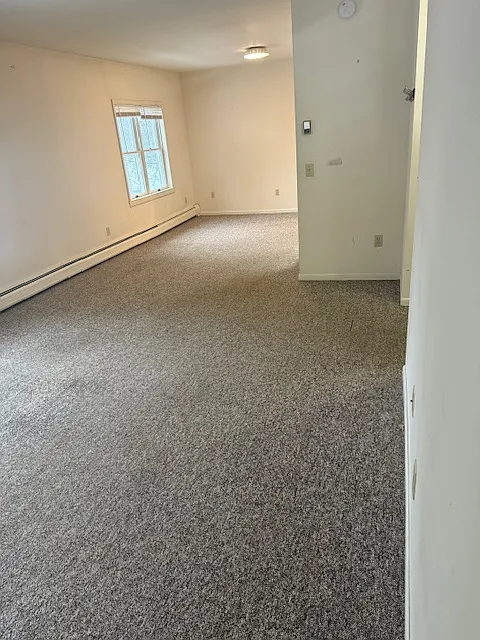 Enter into the large living room space that opens into a dining room.