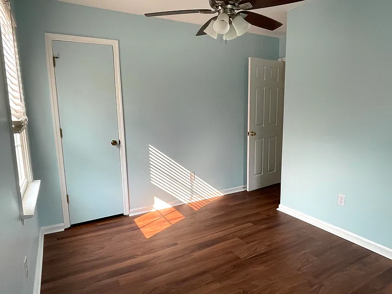 Bedroom 3 with ceiling fan, fresh paint and brand new luxury vinyl flooring.