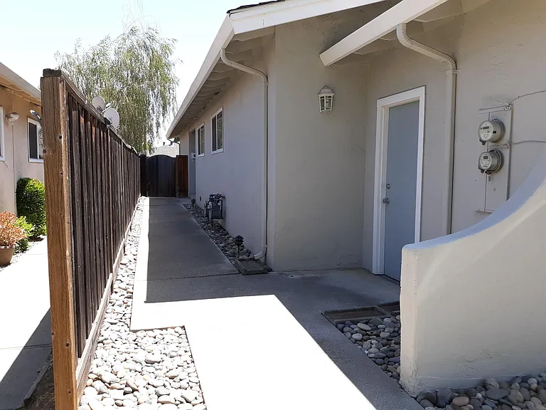 Front door is down the sidewalk.