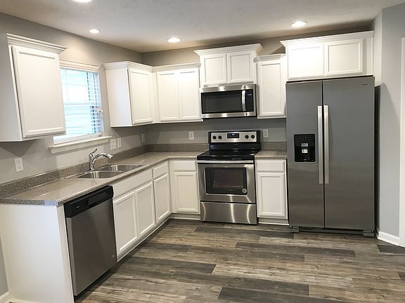 Stock photo of other plan using same color palette . Stainless appliances, laminate in great room a