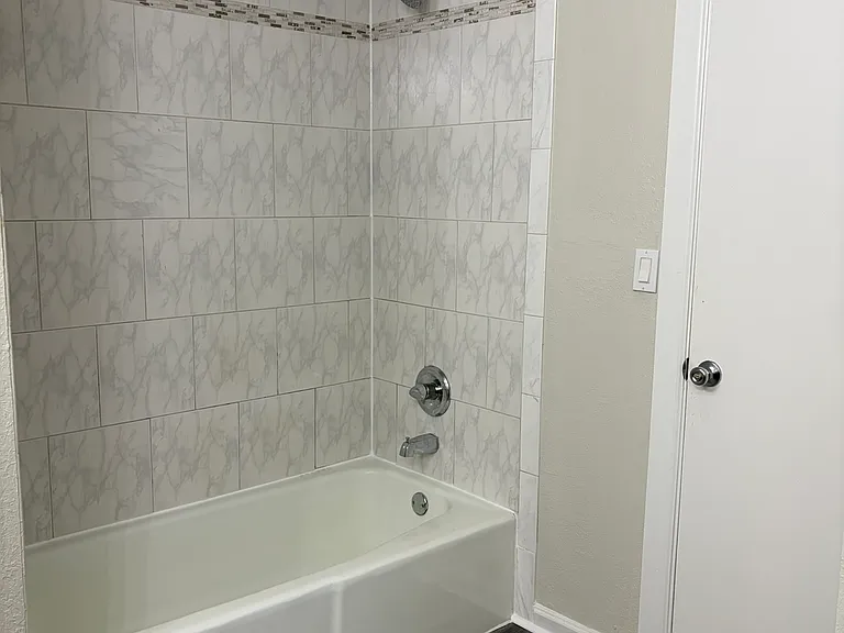 View of downstairs bathroom with shower and tub.