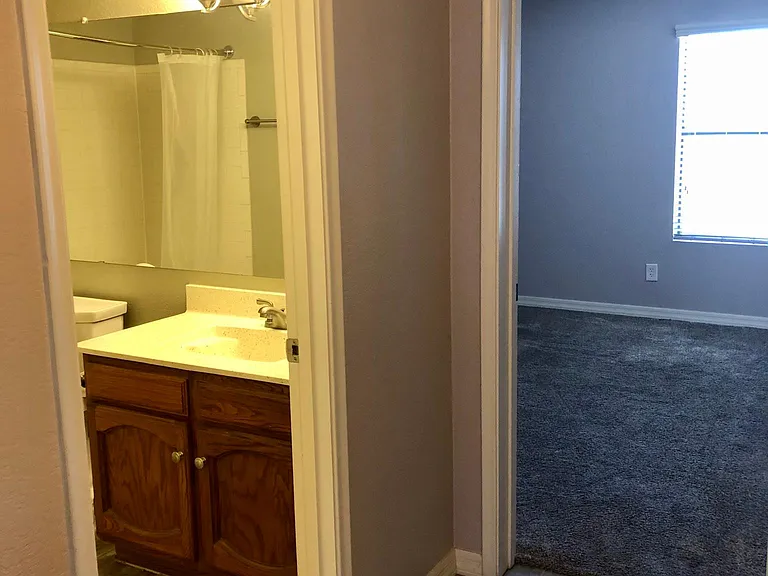 hallway leading to the full bathroom and 2nd bedroom