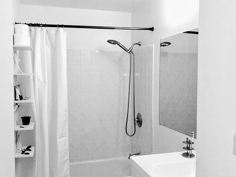 Newly updated bath and fixtures with ample storage. White tile floor and walls.