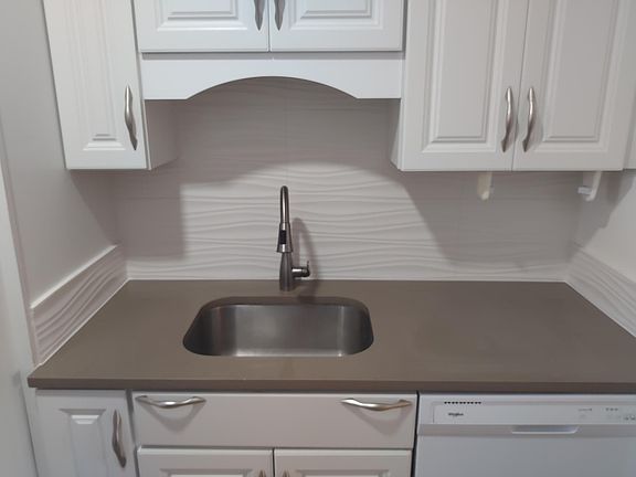 Quartz countertops and modern backsplash
