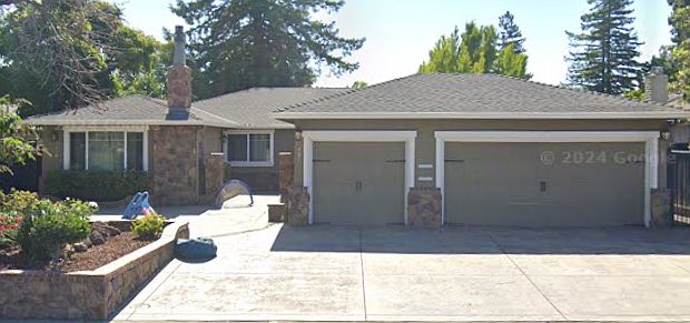 The duplex is on the left side with a detached one car garage