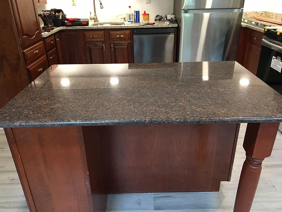 Cherry and granite island in kitchen. There is also room for a dinette next to new windows on the other side of the kitchen.