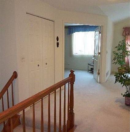 Airy upper Foyer leads to both living areas and the bedroom wing.