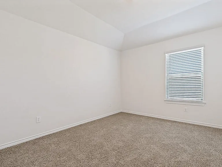 Room featuring light neutral-toned walls and complementary carpet flooring