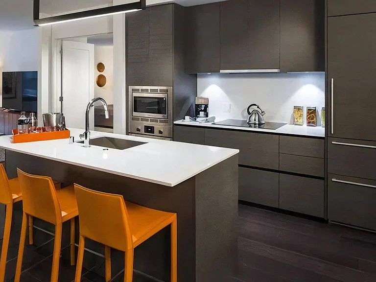 Full Wall Kitchen with Upper and Lower Cabinets and Under-Cabinet Lighting