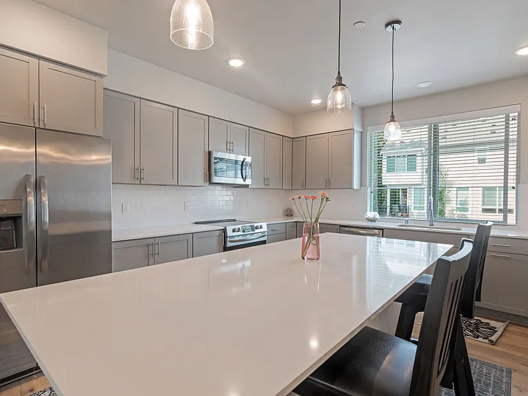 Expansive kitchen with quartz countertop and large island, ideal to host large gatherings.