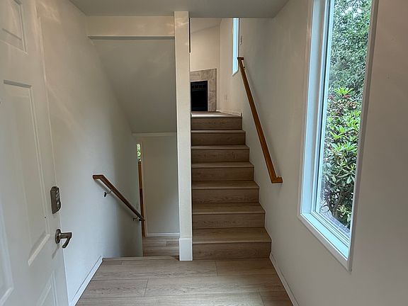 Front entry splits up to the main level (living, dining, kitchen, and back deck) and down to the lower level's 2 bedrooms, full bath, laundry area and storage closets.