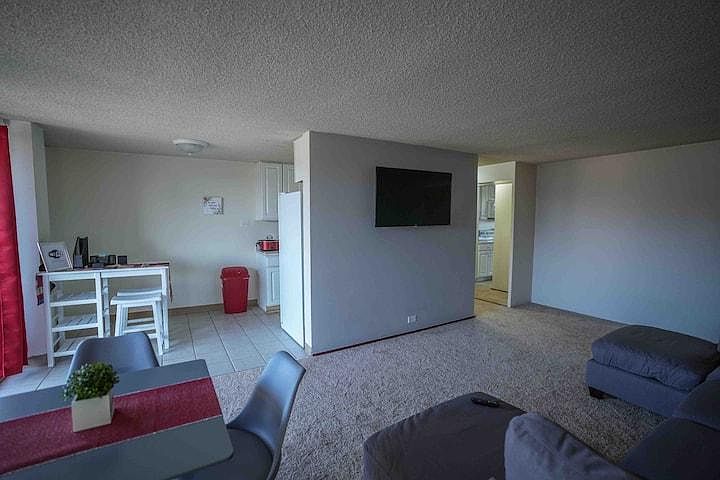 Open floor plan with floor to ceiling glass sliding doors in both living and bedroom.