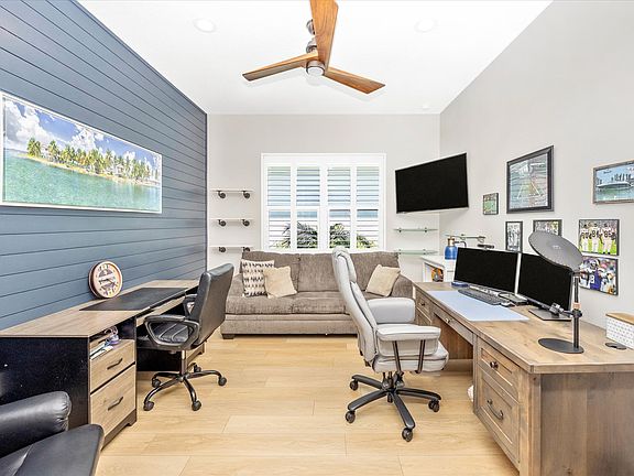 Office on the left with sliding barn doors is large with his and hers desks, computer equipment and a sofa bed!