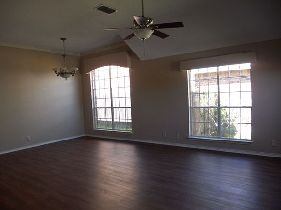 Huge living room with vaulted ceilings, and large windows!