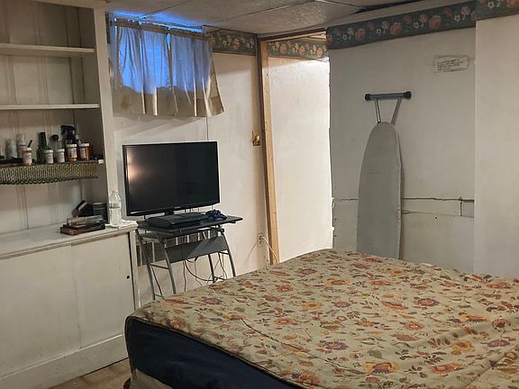 Bedroom with full-size bed in it clothing unit TV, clean comfortable warm winters