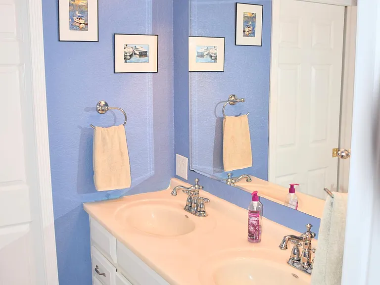 Sinks with closet beyond.