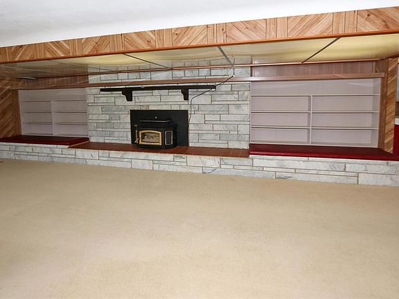 Built in book cases flank the stone fireplace with built in seats with storage.