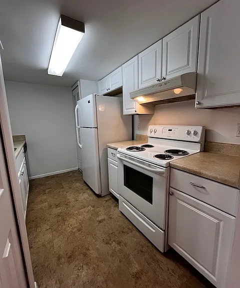 Kitchen - view stove and fridge