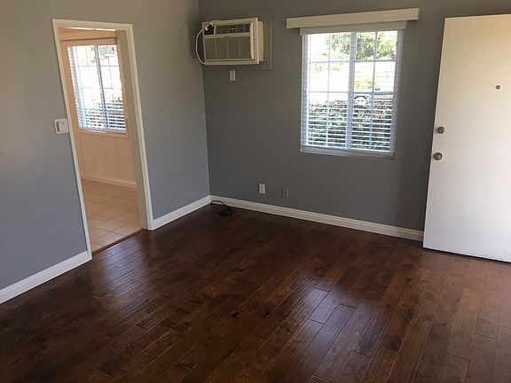 Alternate view of living area. Main door to the right. Kitchen entry on the left.