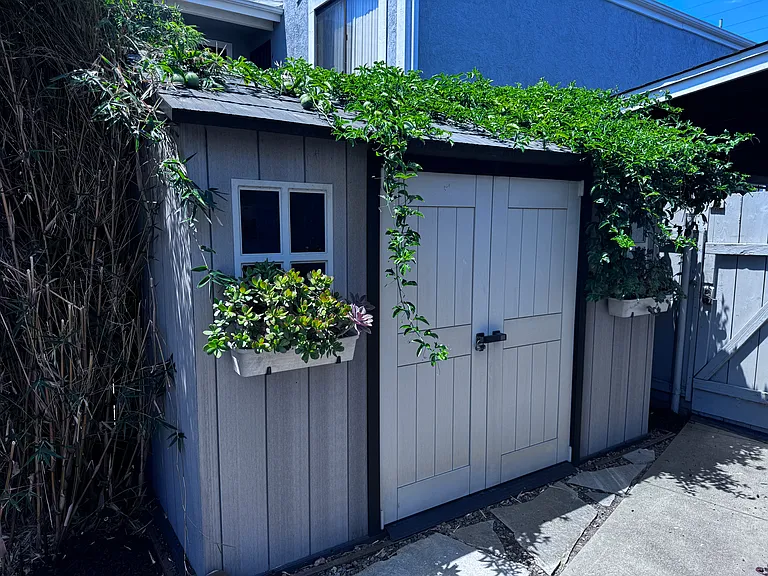 The 2nd backyard storage. This yard has passion fruit, pomegranate, apple, orange and lime trees, plus a raised garden bed along the back of the property. A two car garage, plus the driveway on the front of the house provides plenty of parking.