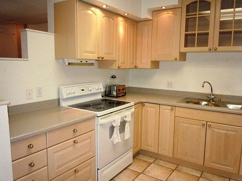White maple cabinets and corian counters