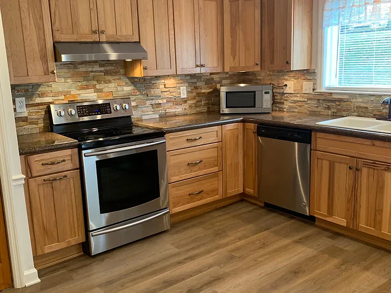 Updated kitchen with all stainless steel appliances.