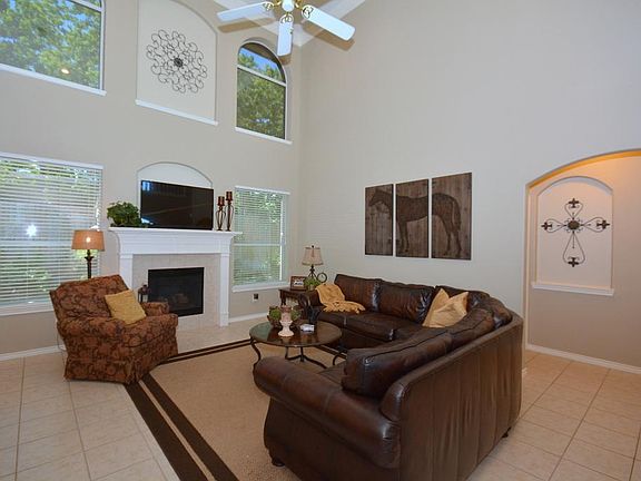 Living area features neutral ceramic tile and a gaslog fireplace!