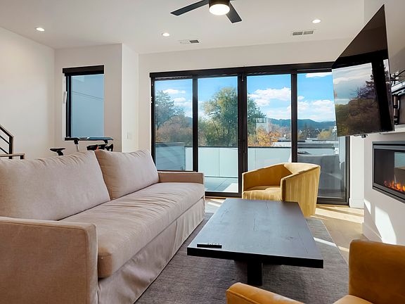 Living space with doors to mid level deck.