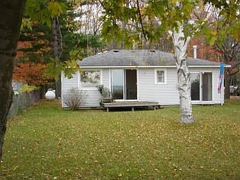 Whether you enjoy summer by the lake or winters by the wood stove, this cozy and efficient cottage o