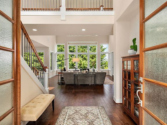 A voluminous, light-filled entry opens to a spectacular great room.