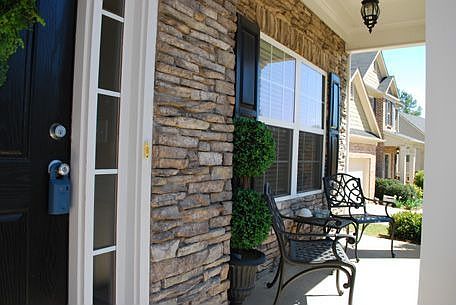 This Craftsman Style home features a Rocking Chair Front Porch