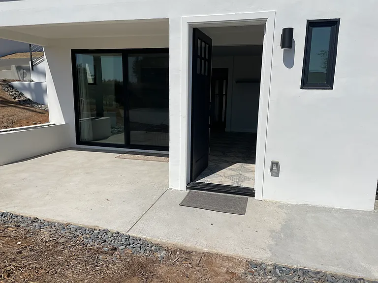 Front door and sliding doors to patio.