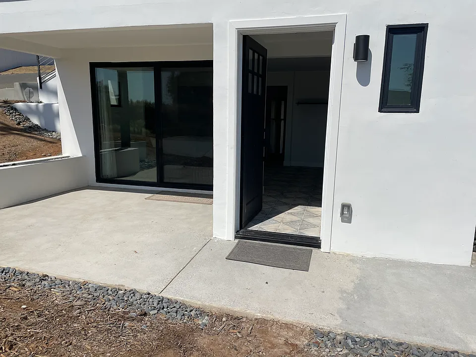 Front door and sliding doors to patio.