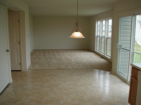 View from kitchen through dining and family room area. Deck and partially fenced yard added after this picture taken.