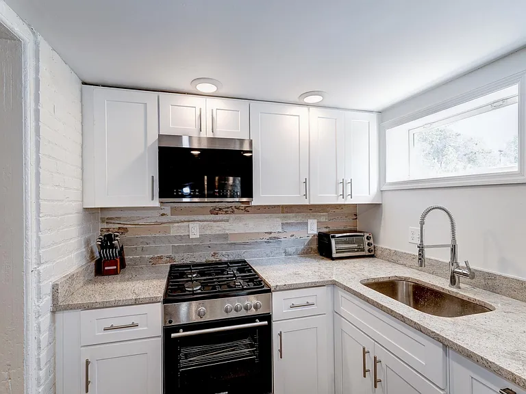Sunny kitchen with loads of granite counters!
