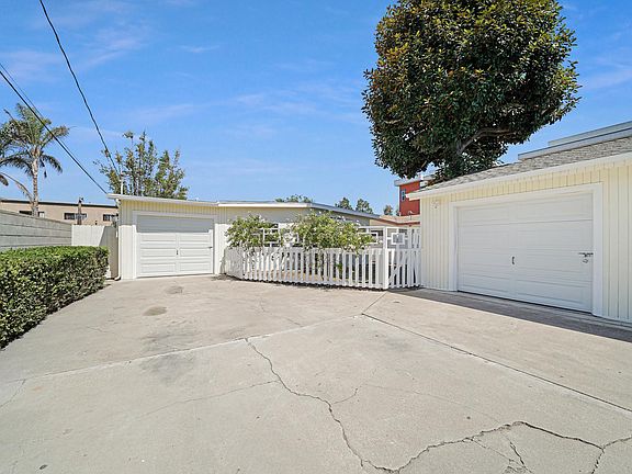 front of house with off street parking and 2 one car garages