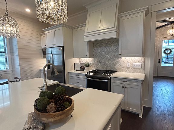 Easy to clean quartz counters, marble backsplash and stainless appliances.