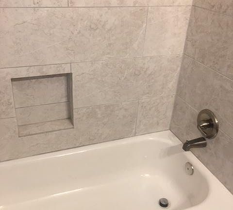 Renovated, tiled bath
