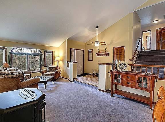 Large tiled entry with ceiling fan.