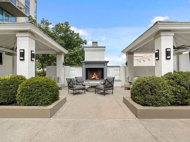 An intimate outdoor retreat designed for conversation and connection, featuring cozy seating areas centered around a warm fireplaceperfect for evening gatherings
