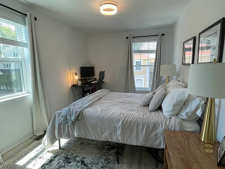 2nd floor guest bedroom 1 with plenty of light and a distant view of the water