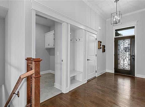 Nice spacious entryway. Beautiful front door and natural hardwood floors. Access to the laundry roo