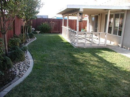 Gorgeous backyard has large covered patio and nice landscaping.