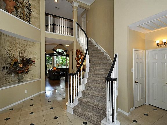 2 story entry with faux painted art niches and marble flooring.