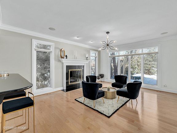 Formal living room with bar and fireplace.