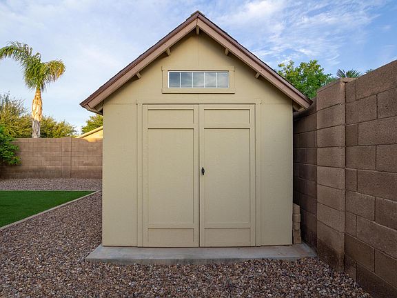 LARGE STORAGE SHED in backyard measures ( 12' L x 8' W x 10' H ) on concrete foundation