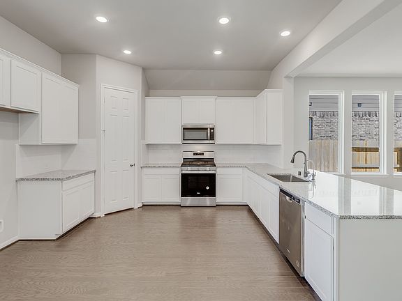 White kitchen featuring a long peninsula and plenty of counterspace