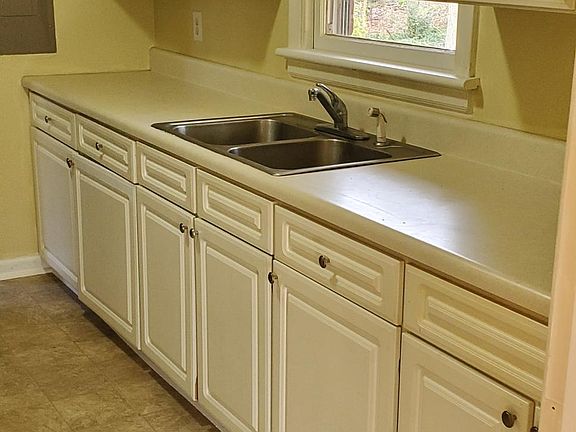 Galley Kitchen w/ White Cabinets- One View